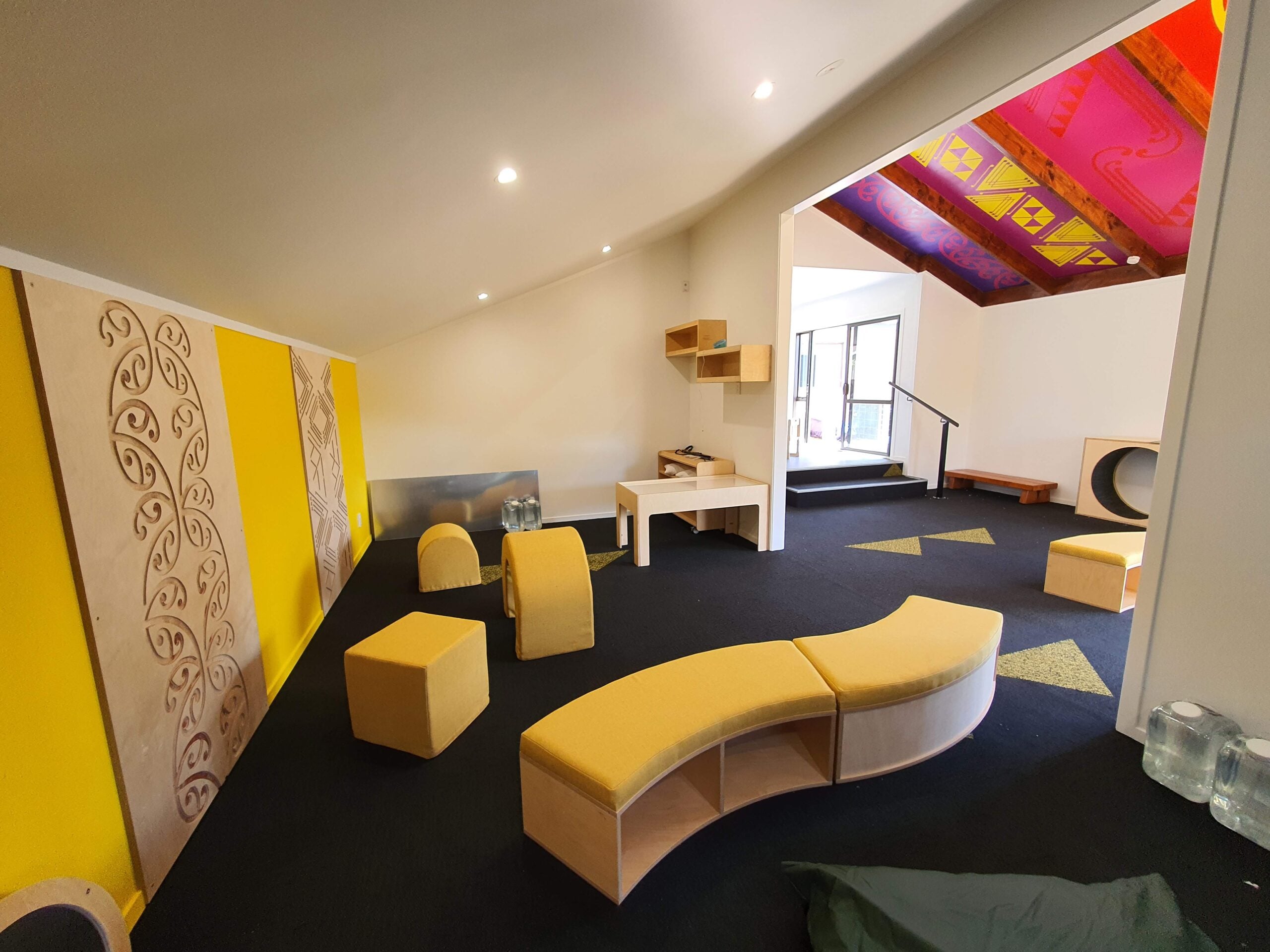 Acoustic wall panels installed above joinery in a centre