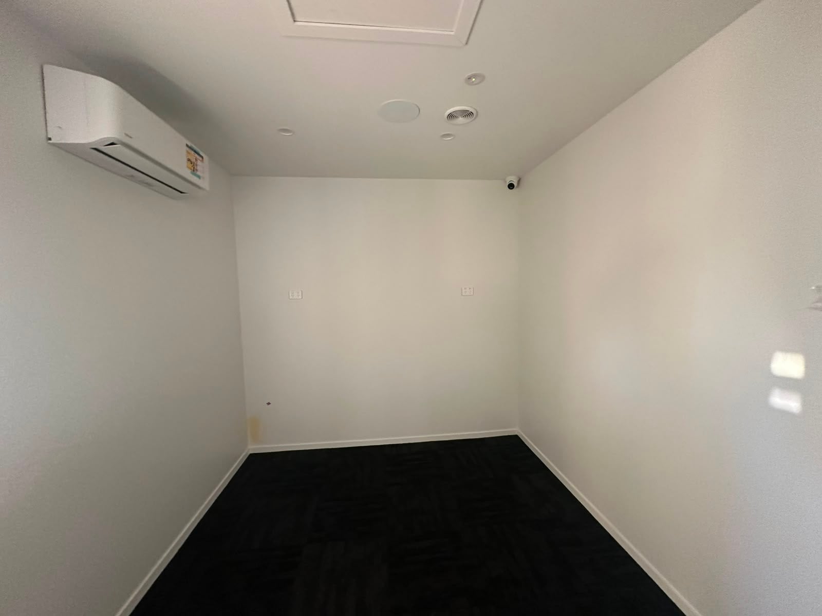 Sleep room with bare white walls before acoustic wall panels were installed